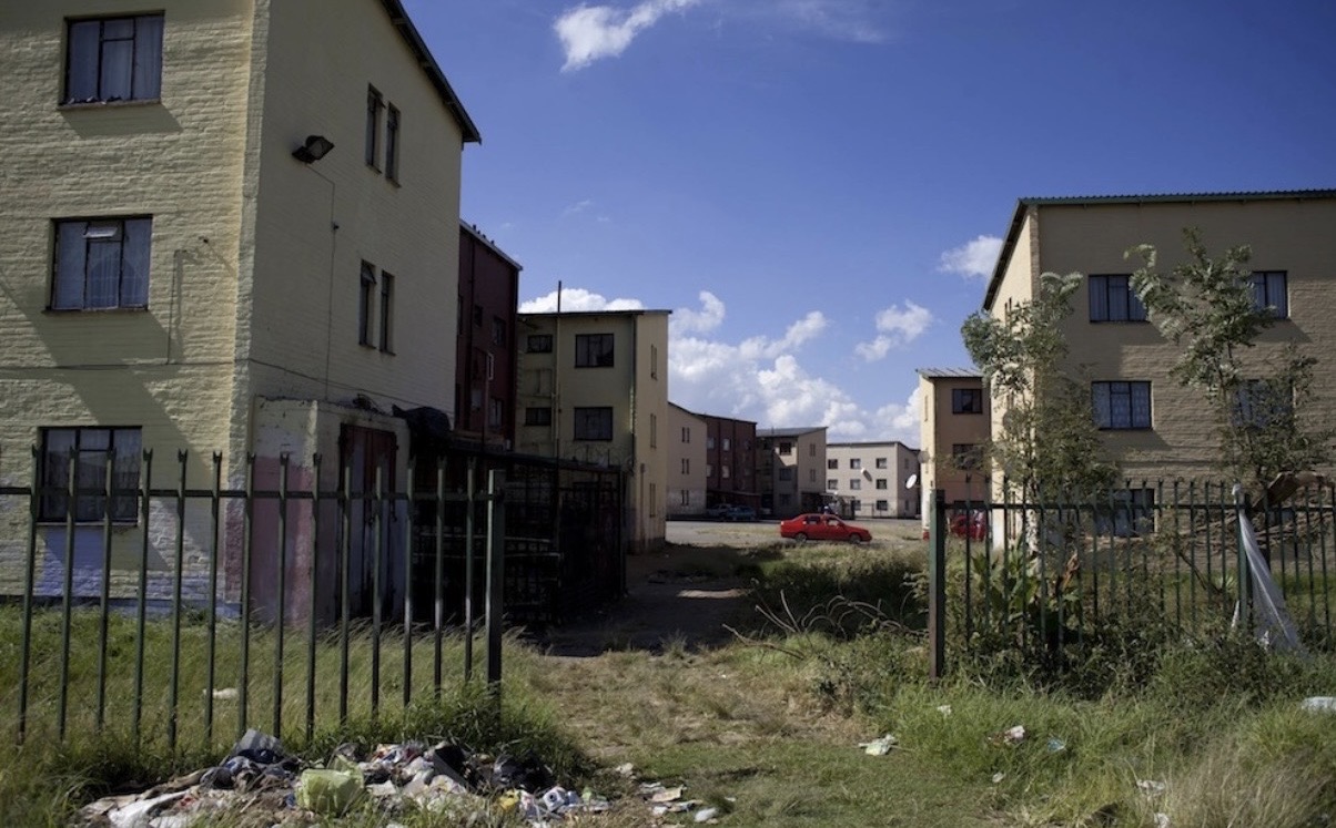 Eldoradopark township flats with rubbish in the foreground